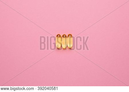 Vitamins Omega 3 6 9 Fish Oil , Vitamin D On A Pink Background For Health Lifestyle With Copyspace