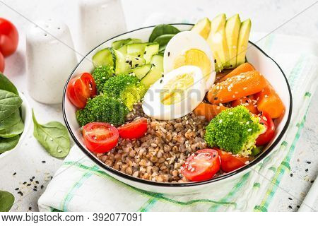 Buddha Bowl. Vegan Food With Buckwheat, Egg, Avocado And Fresh Vegetables. Healthy Eating, Diet Menu