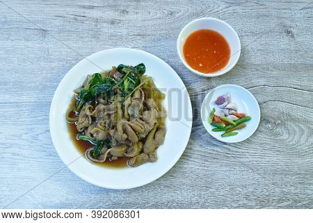 Braised Pork Innards In Black Chinese Herb Soup On Plate Dipping Spicy Sauce Eat Couple Fresh Chili 