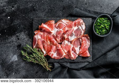 Italian Rolled Bacon Pancetta Piacentina. Pork Meat. Black Background. Top View