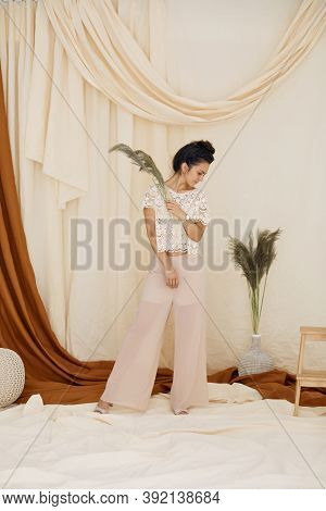 Fashion Art Photo Of Brunette Woman In Studio Interior. Soft Light. Full Lenth Photo. Trendy Fabric 