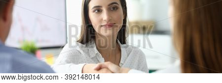 Portrait Of Joyful Businesswoman Sitting At Modern Workplace And Shaking Hand With Woman Partner. Bu