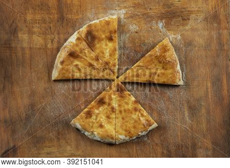 Baked homemade  cheese pie on wooden background. Bulgarian banitsa, Georgian khachapuri, Greek tirop