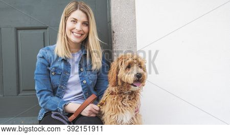 Labradoodle Dog And Woman Outside On Balcony
