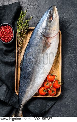 Fresh Whole Japanese Amberjack. Raw Fish Yellowtail. Black Background. Top View