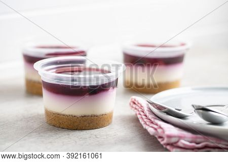 Sweet desssert. Cheesecake cup on kitchen table.