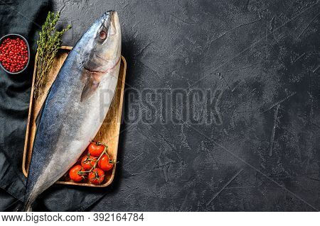 Fresh Whole Japanese Amberjack. Raw Fish Yellowtail. Black Background. Top View. Copy Space