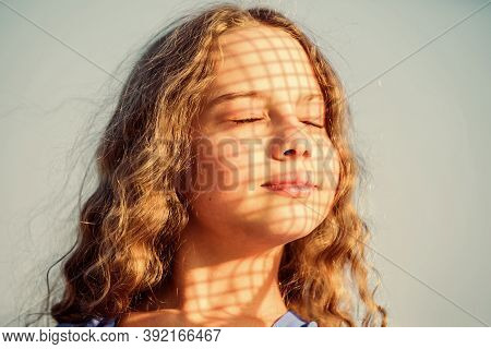 Take Care. Summer Care. Sunscreen Concept. Child Pleased With Warm Sunlight Looks Relaxed Blue Sky B