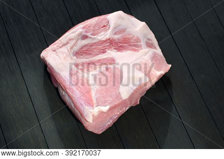 A Piece Raw Pork Shoulder. Pork Tenderloin On A Wooden Dark Table. Fresh Raw Meat Steak On Dark Back