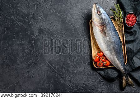 Fresh Whole Raw Japanese Yellowtail. Fish Amberjack. Black Background. Top View. Copy Space