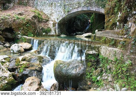 Rocky Bridge Of Candalla Over The River Waters In The Tuscan Mountains In Italy On Summer