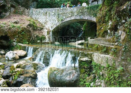 Rocky Bridge Of Candalla Over The River Waters In The Tuscan Mountains In Italy On Summer