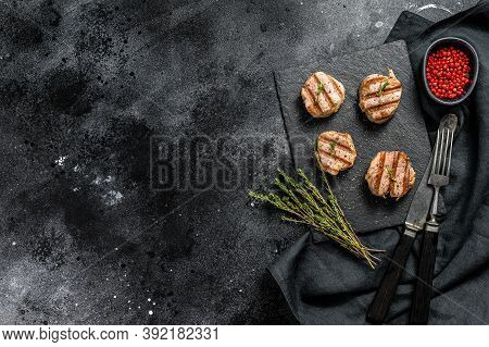 Tender Boneless Grilled Pork Chops. Steak Tenderloin. Black Background. Top View. Copy Space