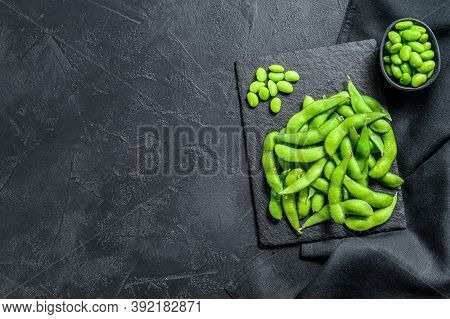 Raw Green Edamame Soybeans. Black Background. Top View. Copy Space