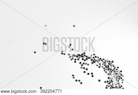 Background Of Twinkling Silver Stars. Scattered Confetti From Crackers.