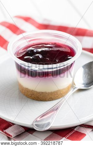 Sweet desssert. Cheesecake cup on plate.