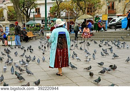 The Back Of A Female Street Vendor Selling Sweets On Plaza Murillo, The Central Square In La Paz, Bo