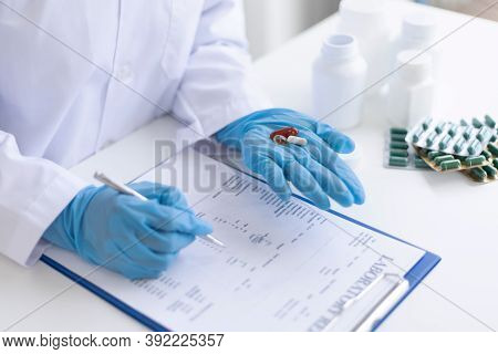 Closeup portrait, Scientists in white lab coats are analyzing the vital substance of the sample drug