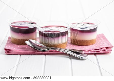 Sweet desssert. Cheesecake cup on pink napkin.