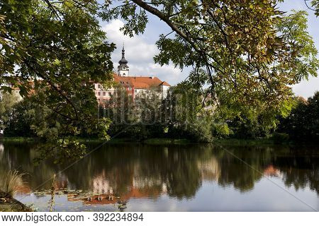 Colorful Medieval Town Pisek Above The River Otava With The Deanery Church, Czech Republic