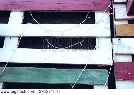 A Wall Of Multi-colored Wooden Planks. Rustic Style. Side View