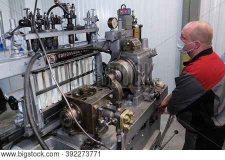 Test Bench For Checking The Injection Pump Of An Industrial Diesel Engine. Glass Flasks With Diesel