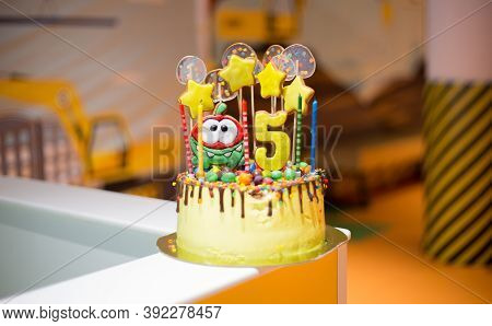 Yellow Beautiful Delicious Chocolate Cake With Gingerbread Decorations. Edible Stars And Candy On Th