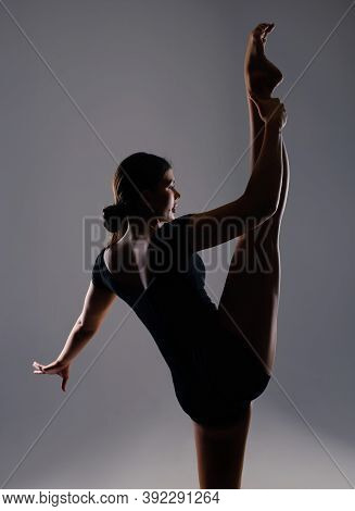 Beautiful Athletic Young Girl Gymnast In Sportswear Performs Stretching. Training, Elements Of Gymna