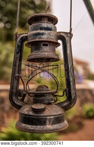 Old Green Gasoline Lantern Hanging With Blurred Background