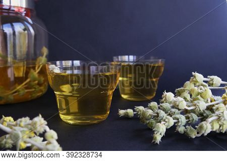 Cups Of Herbal Tea On A Black Background. Tatar Tea Or Lemongrass.
Top View With Space For Text.