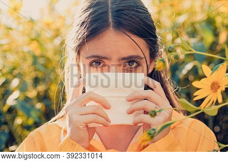 Young Woman Is Going To Sneeze. The Girl Suffers From Pollen Allergy During Flowering And Uses Napki
