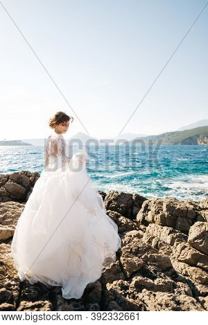 Beautiful Bride In Tender Wedding Dress On The Rocky Beach Of The Mamula Island