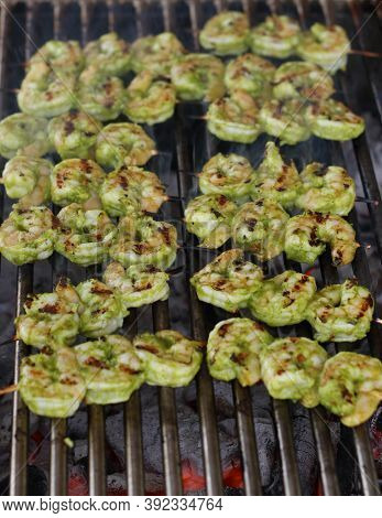 Spice Marinated Prawns Skewers On A Charcol Grill