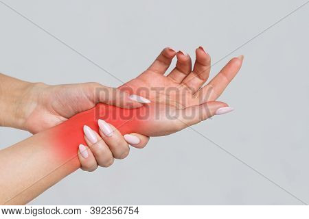 Female Arms Holding Her Painful Wrist Caused By Prolonged Work On The Computer, Laptop, Coloured In 