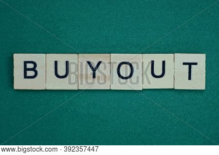 Gray Word Buyout Made Of Wooden Square Letters On Green Background