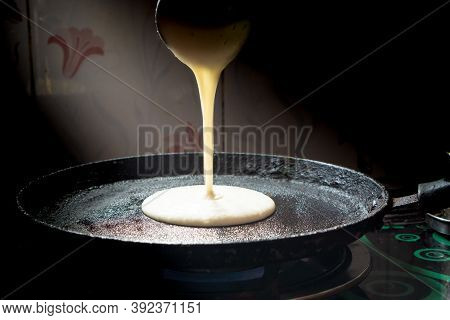 Fresh Dosa Batter Poured On A Hot Tawa On A Flame