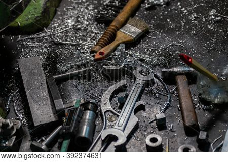 Set Of Tools Covered With Aluminium Metal Swarf On Machinery Worker Table