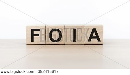 Word Foia. Wooden Cubes With Letters Isolated On Light Background With Copy Space Available. Busines