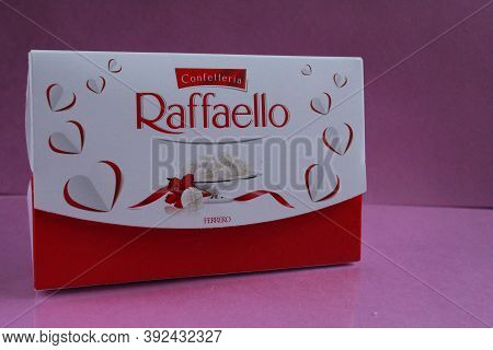 Raffaello\'s Square Rectangular Gift Box Stands On A Fuchsia Pink Background Side View Of Copy Space