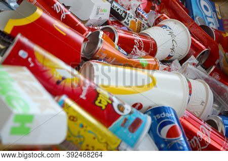 Many Wrappings And Cans From Used Products By Famous Worldwide Brands. Pattern Of Trash Of Various C