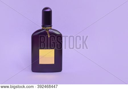 Tom Ford Velvet Orchid Fragrance Perfume Bottle Lies On Light Lilac Background. Tom Ford Is American