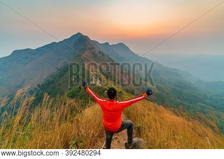 Traveler Man Hiking Enjoying In The Mountains With Backpack At Khao Chang Puak Mountain Thailand.