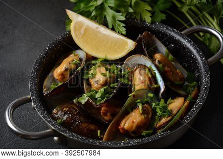 Classic French Meal Moules Marinière  Marinara Mussels With Garlic, Sauce, Lemon And Parsley.