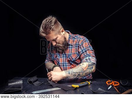 Leather Man Processing A Leather Workpiece At The Workplace
