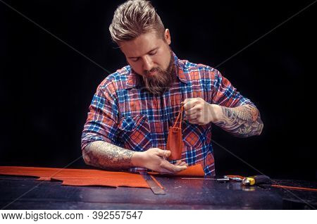 Leather Currier Works With Leather At The Work Area
