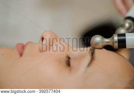 Top Macro Close Up View Of Women Facial Massage Spa Procedure. Electric Stimulation Facial Skin Care