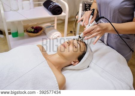 Lateral View Of Woman Facial Massage Spa Procedure. Electric Stimulation Facial Skin Care. Microcurr