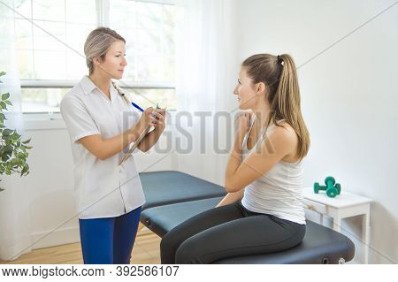 A Modern Rehabilitation Physiotherapist At Work With Client