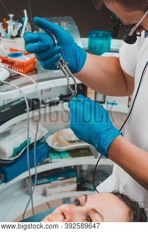 Installation Of A Rubber Dam With A Metal Clamp For Dental Fillings, Sterile And Modern Dental Treat