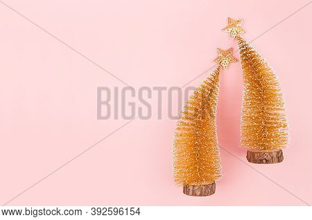 Luxury New Year Gold Shimmer Decor With Christmas Trees, Stars On Soft Light Pink Background, Top Vi